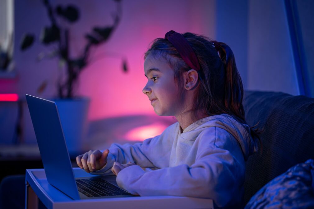 Little girl uses a laptop