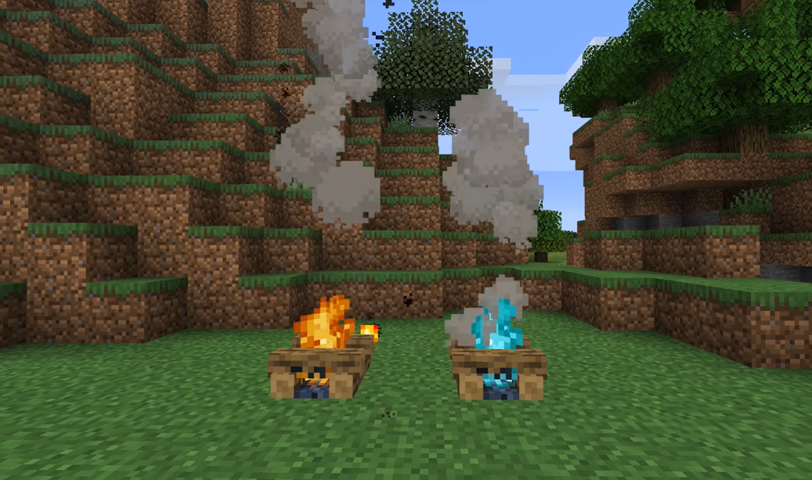 two campfires with blue and yellow fire on the green land