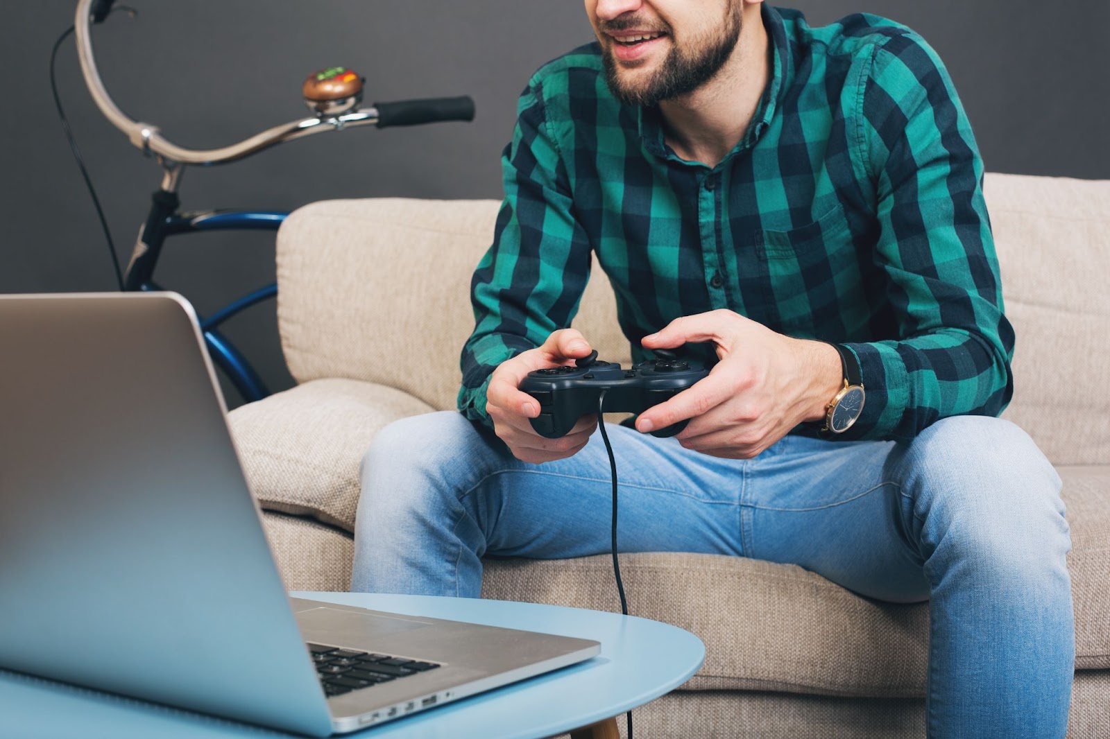 Man sitting on couch playing video game